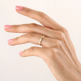 Model wearing a 14k gold vermeil unique wedding band with sculpted facets that reflect light beautifully, blending contemporary style with classic warmth.
