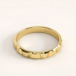 Side angle of 14k gold vermeil unique wedding band highlighting its angular facets and smooth inner band for comfortable wear.
