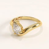 Side view of 14k gold vermeil wavy pear ring highlighting its sculpted wave band and sparkling pear-cut cubic zirconia stone.
