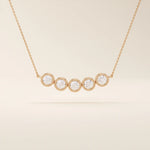 5 stone bezel necklace in 14k rose gold showcasing five bezel-set round stones along a dainty chain.
