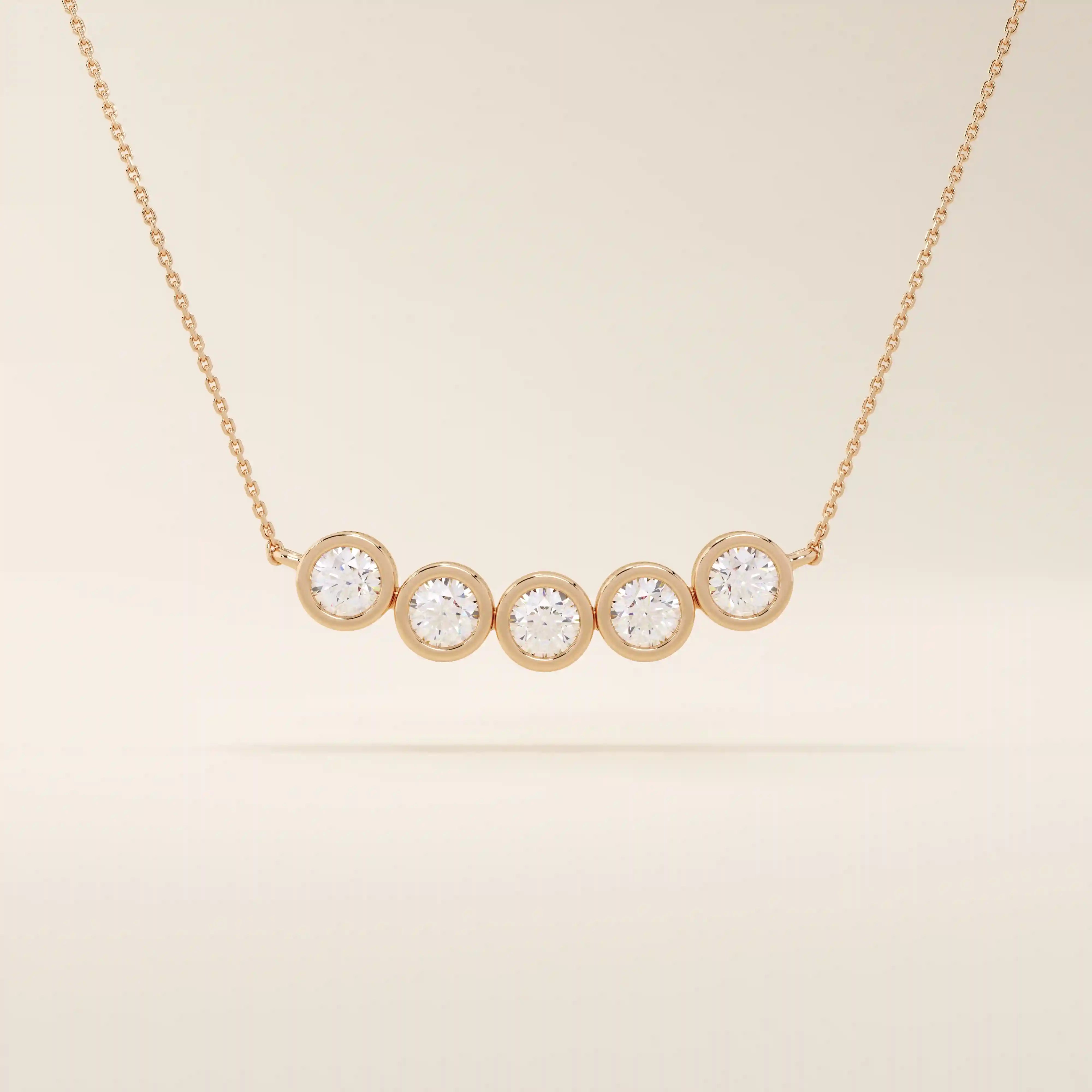 5 stone bezel necklace in 14k rose gold showcasing five bezel-set round stones along a dainty chain.

