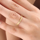 Model wearing a 14k gold vermeil minimalist band ring with ridged design, dainty gold stacking ring for women’s everyday look.

