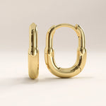 14k gold vermeil oval hoop earrings featuring a bold, rounded silhouette with a high-polish finish, offering a sleek and modern take on the classic hoop.
