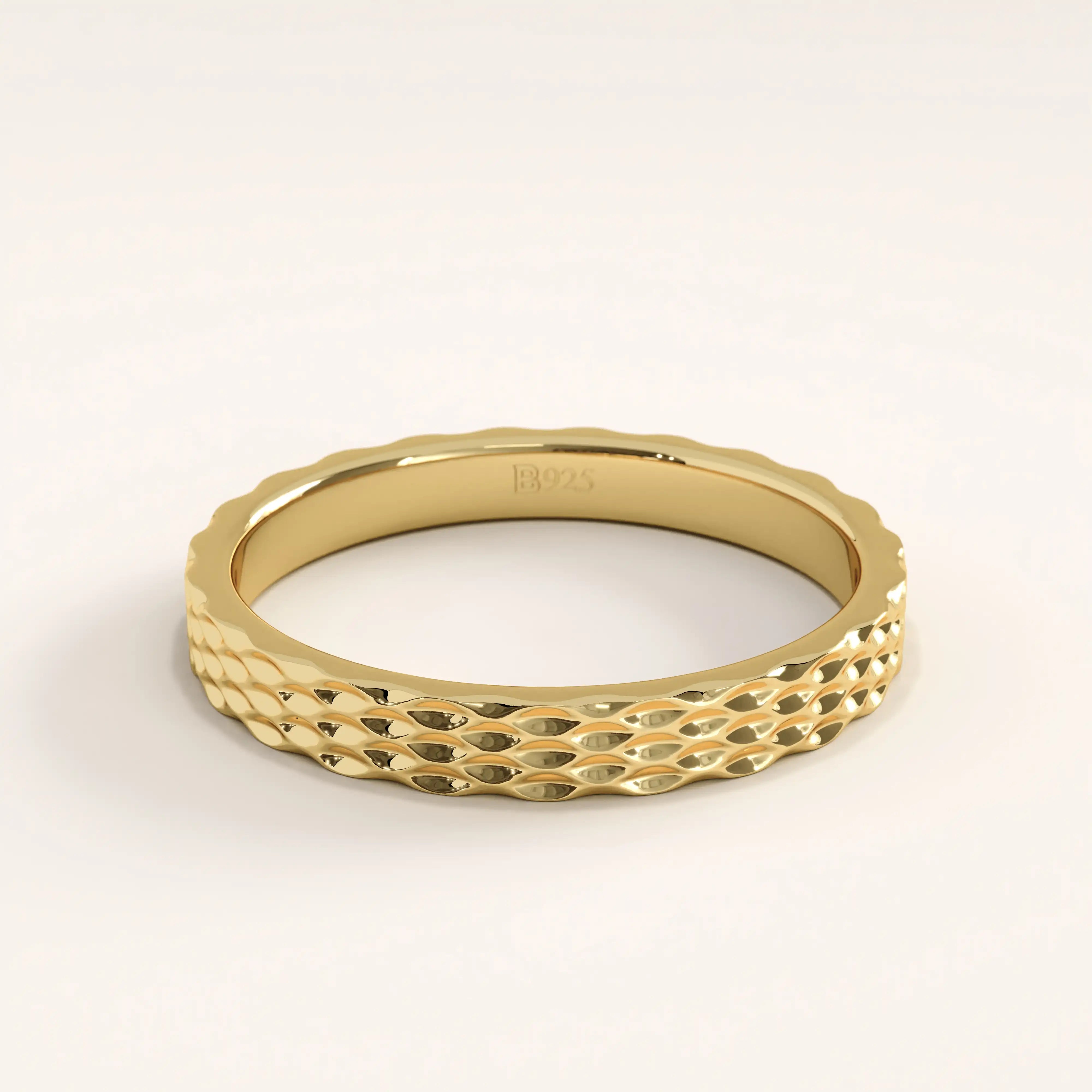 14k gold vermeil patterned band ring featuring a textured geometric surface with a high-polish finish, offering a sophisticated twist on a minimalist design.
