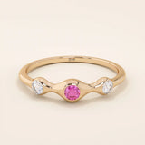 stacking wedding ring with a sparkling lab-grown ruby birthstone with moissanite stones each securely set in a bezel in 14k solid gold for women