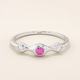 stacking wedding ring with a sparkling lab-grown ruby birthstone with moissanite stones each securely set in a bezel in 14k solid gold for women