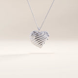 Silver vermeil 3D heart necklace showcasing a dimensional wavy heart design with a luminous cubic zirconia accent, perfect for everyday elegance.
