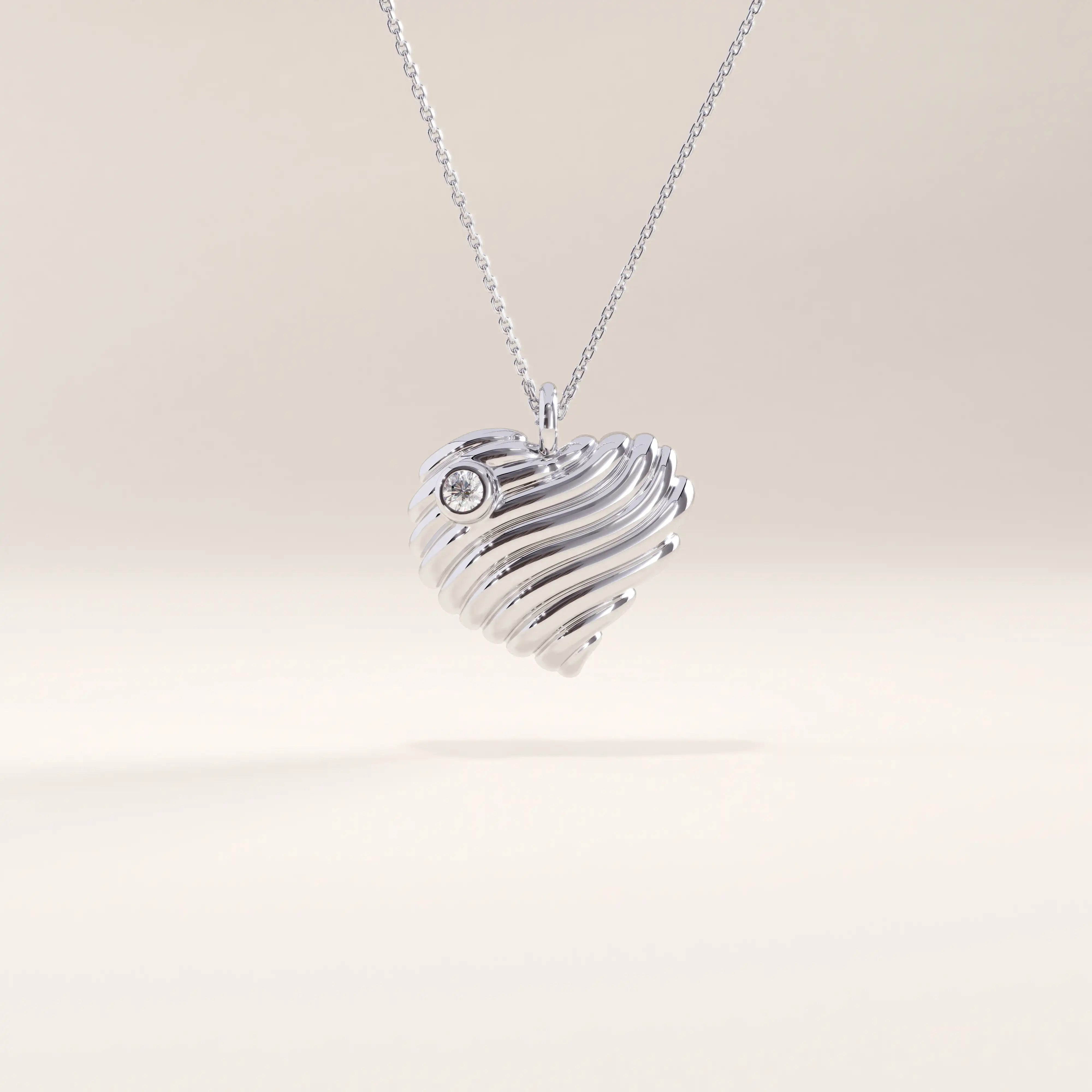 Silver vermeil 3D heart necklace showcasing a dimensional wavy heart design with a luminous cubic zirconia accent, perfect for everyday elegance.
