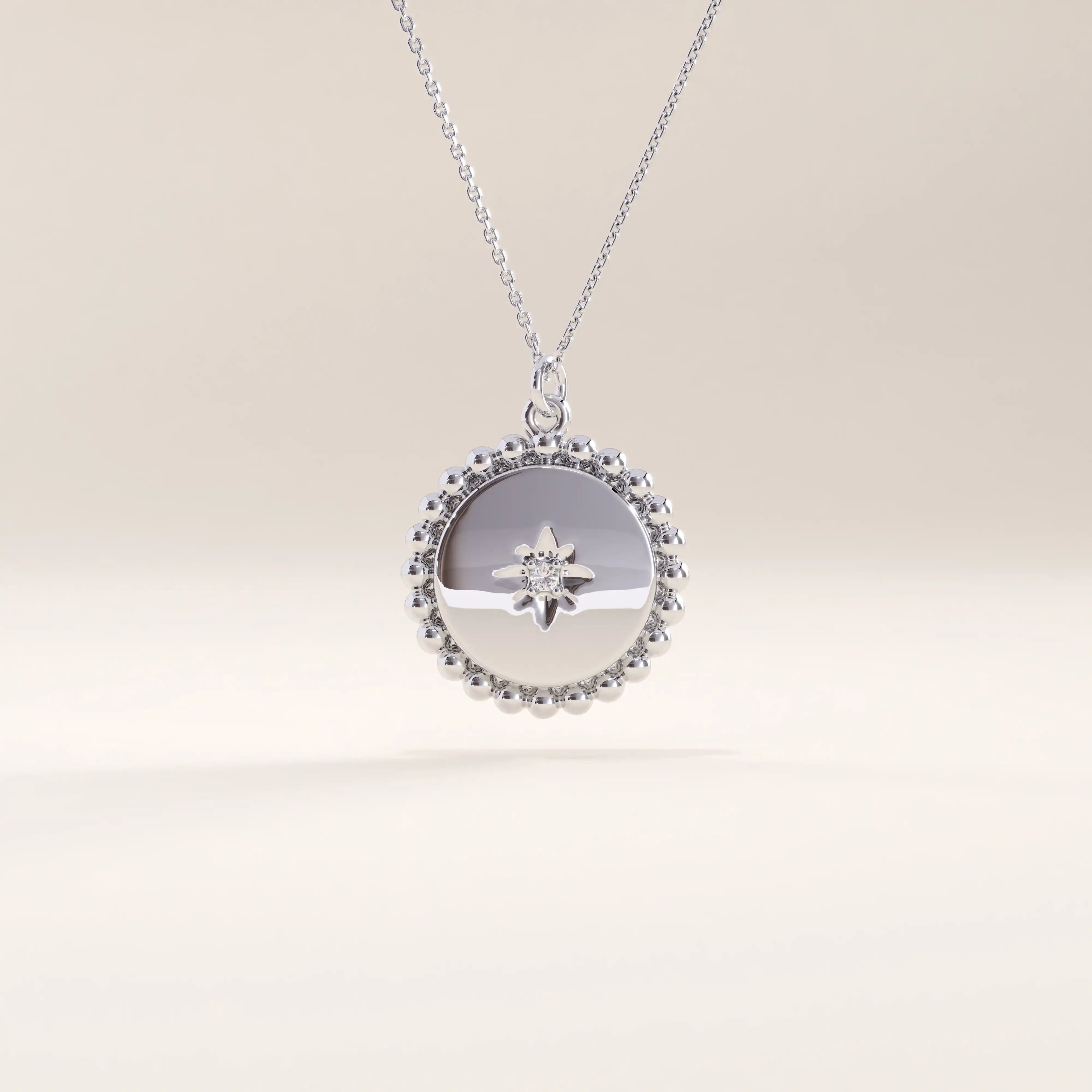 Silver vermeil beaded coin necklace showcasing a smooth circular pendant bordered by fine beading and accented with a small cubic zirconia for refined, timeless charm.
