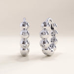 Silver vermeil beaded hoop earrings with smooth rounded beads and delicate cubic zirconia details, adding refined sparkle to a timeless hoop silhouette.
