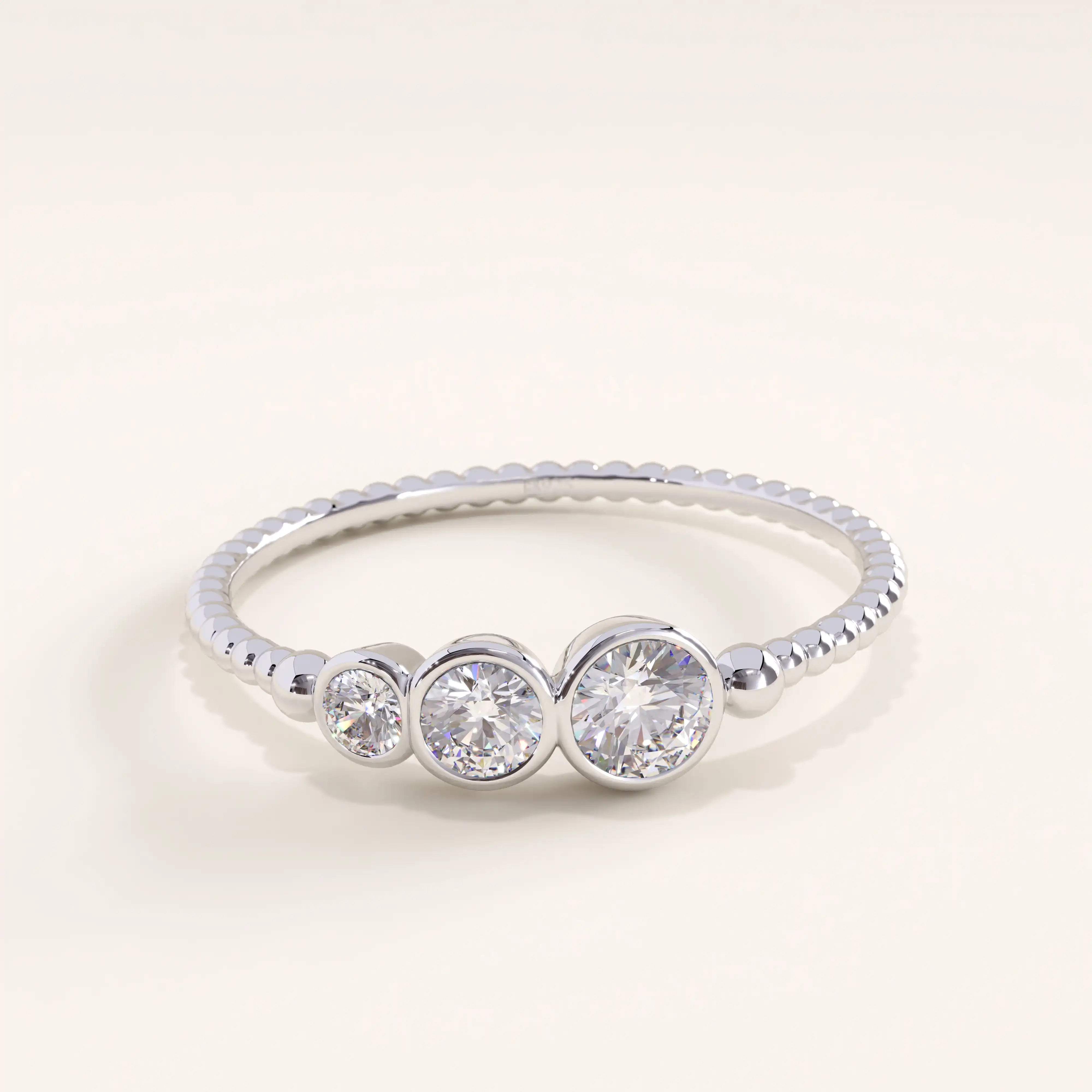 Silver vermeil beaded trio ring with three sparkling cubic zirconia stones set in smooth bezels on a polished beaded band, minimalist yet refined jewelry piece.
