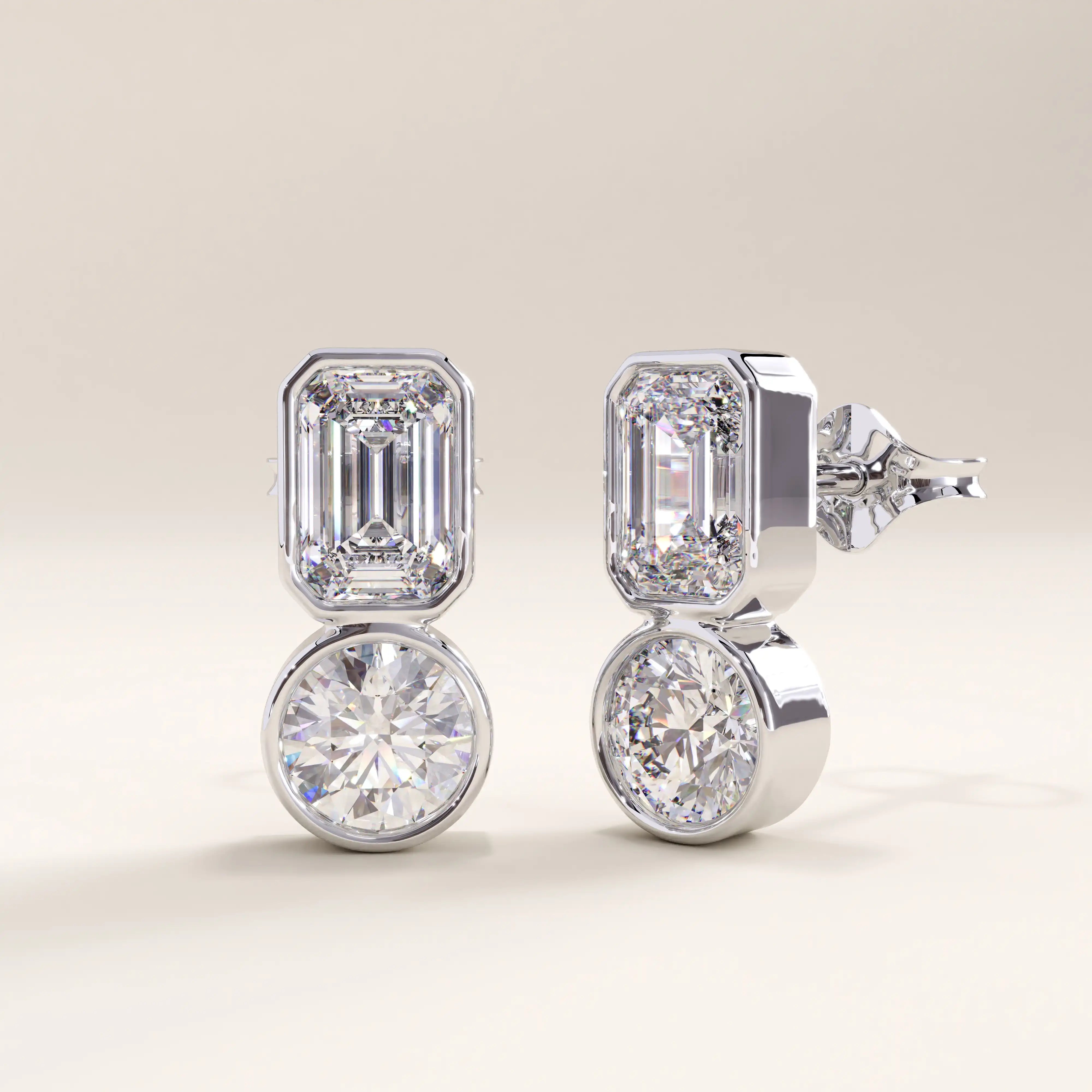 Silver vermeil toi et moi stud earrings showcasing a sleek modern design with emerald and round-cut cubic zirconia stones set in smooth bezels for a balanced, radiant look.
