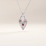 Silver vermeil birthstone heart necklace showcasing a delicate heart lock design with a colored gemstone centerpiece symbolizing birth month and individuality.

