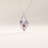 Silver vermeil birthstone heart necklace showcasing a delicate heart lock design with a colored gemstone centerpiece symbolizing birth month and individuality.
