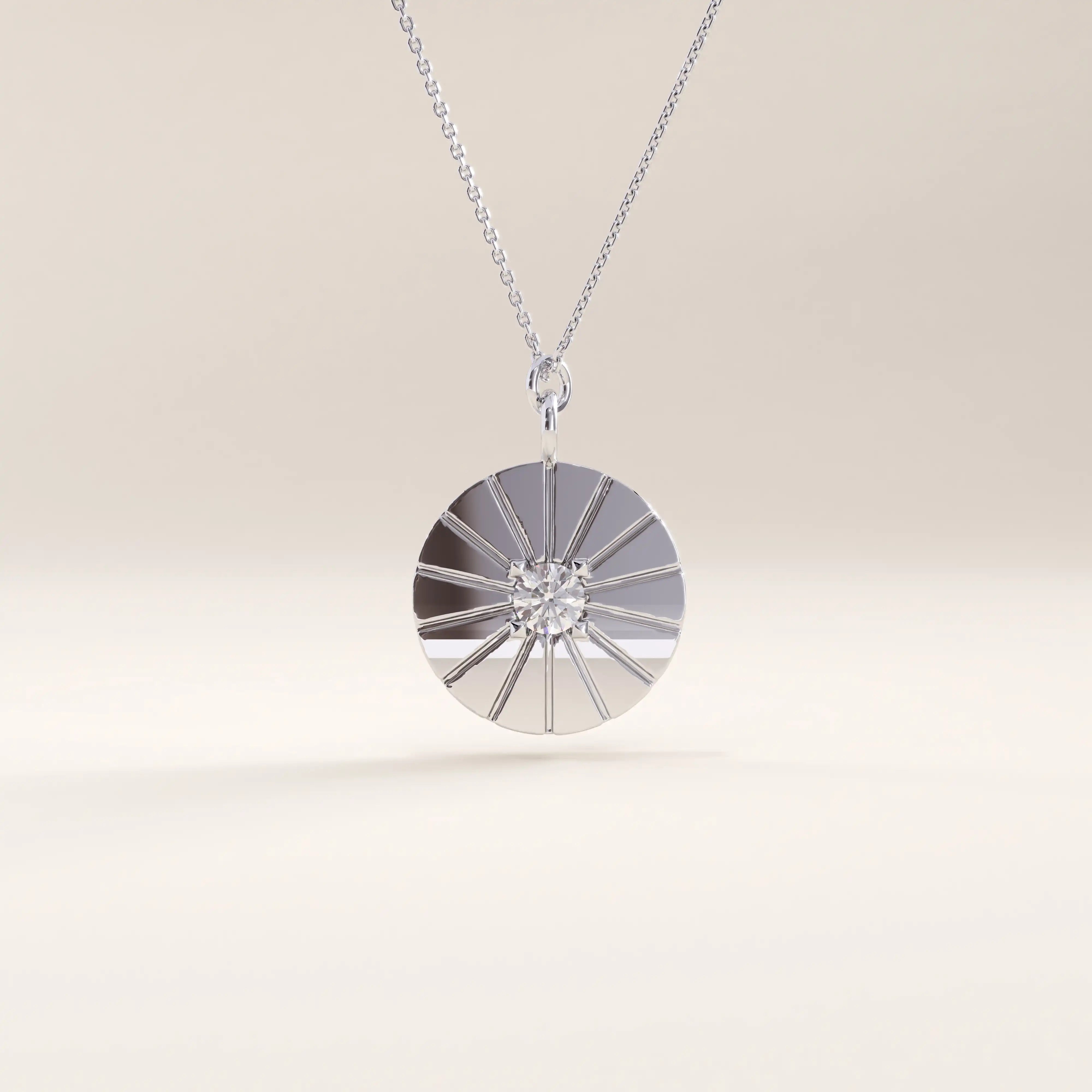 Silver vermeil coin necklace showcasing a circular pendant with a sunburst engraving and a sparkling stone centerpiece, blending elegance and modern charm.
