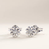 Silver vermeil daisy stud earrings crafted with a polished petal design and a sparkling cubic zirconia centerpiece, combining playful beauty with classic sophistication.
