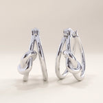 Silver vermeil knot hoop earrings with a graceful interlocking design that adds modern refinement and subtle texture to any look.
