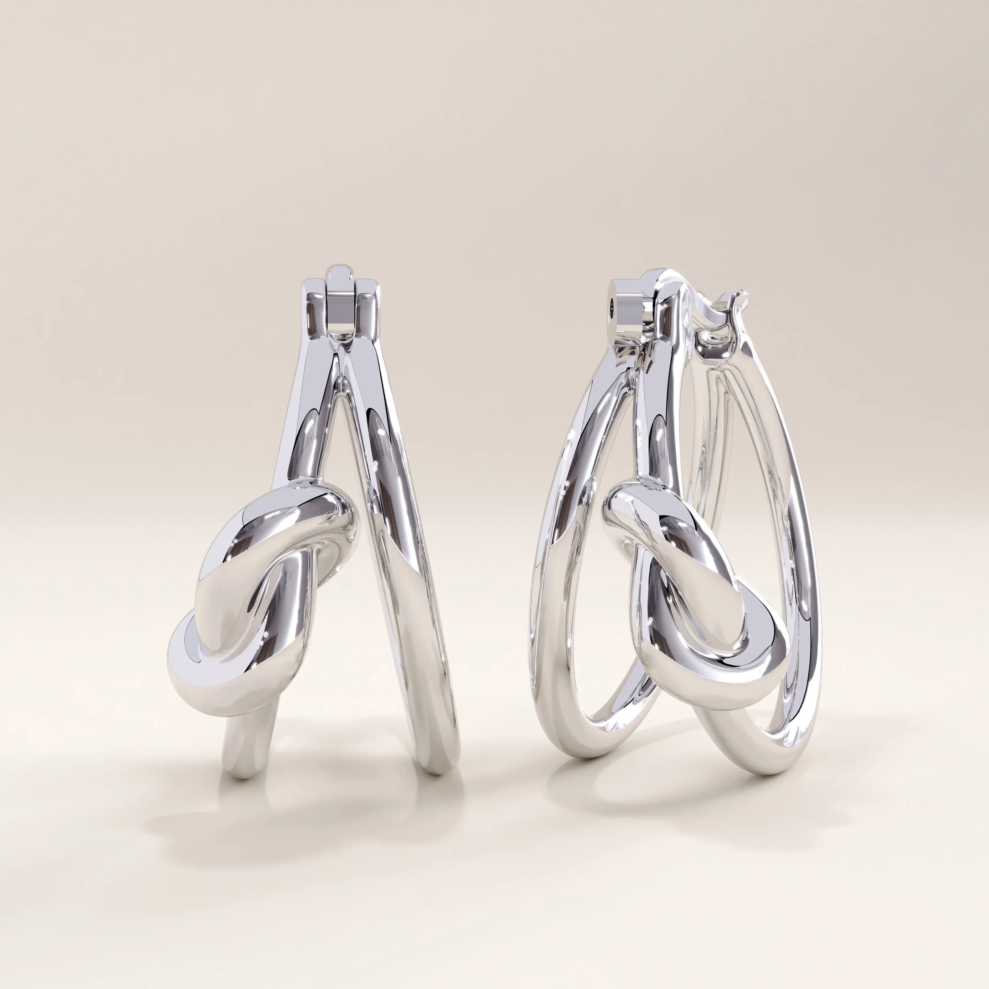 Silver vermeil knot hoop earrings with a graceful interlocking design that adds modern refinement and subtle texture to any look.
