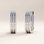 Silver vermeil line hoop earrings showcasing modern linear detailing and a polished finish, blending architectural form with everyday elegance.
