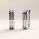 Silver vermeil line hoop earrings showcasing modern linear detailing and a polished finish, blending architectural form with everyday elegance.
