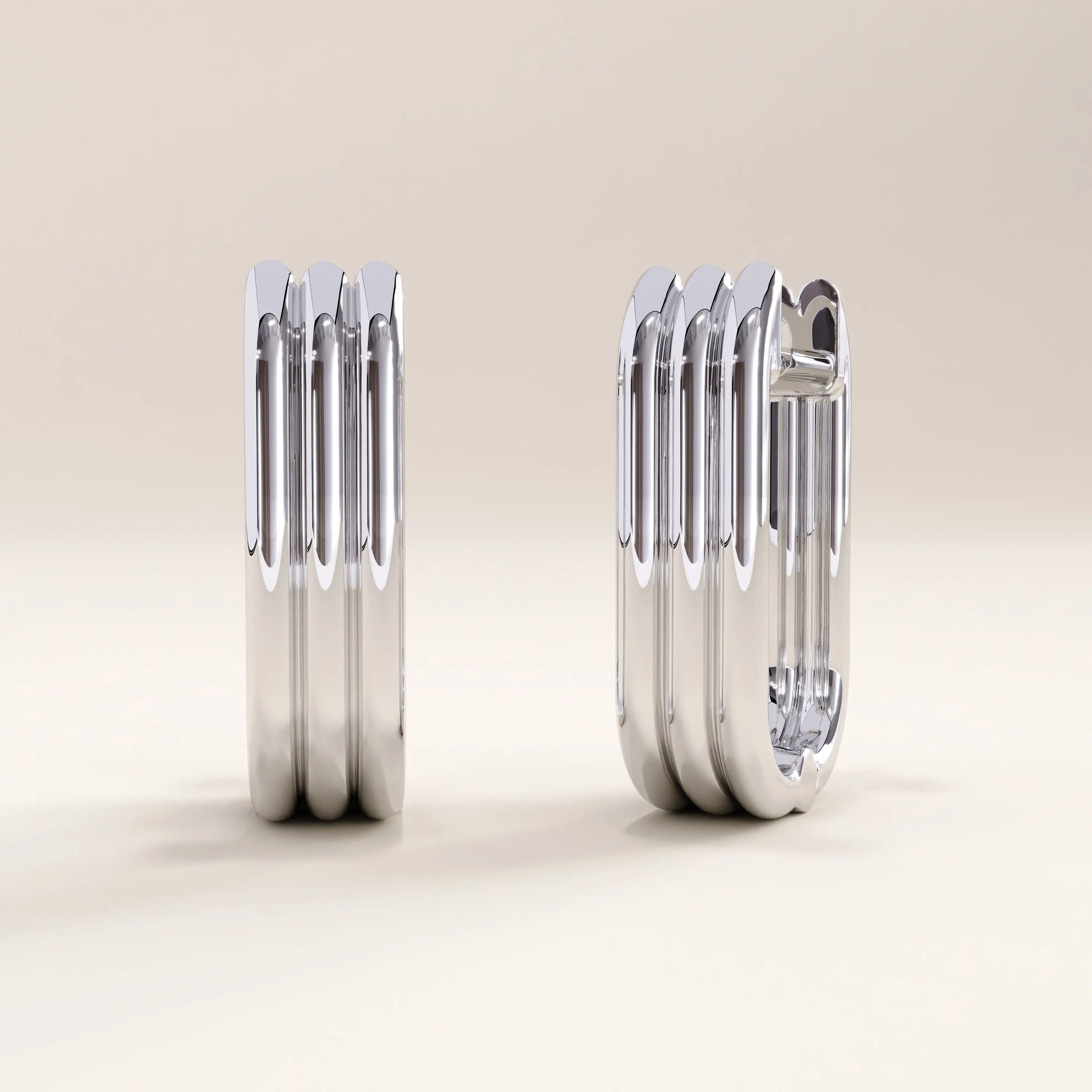 Silver vermeil line hoop earrings showcasing modern linear detailing and a polished finish, blending architectural form with everyday elegance.
