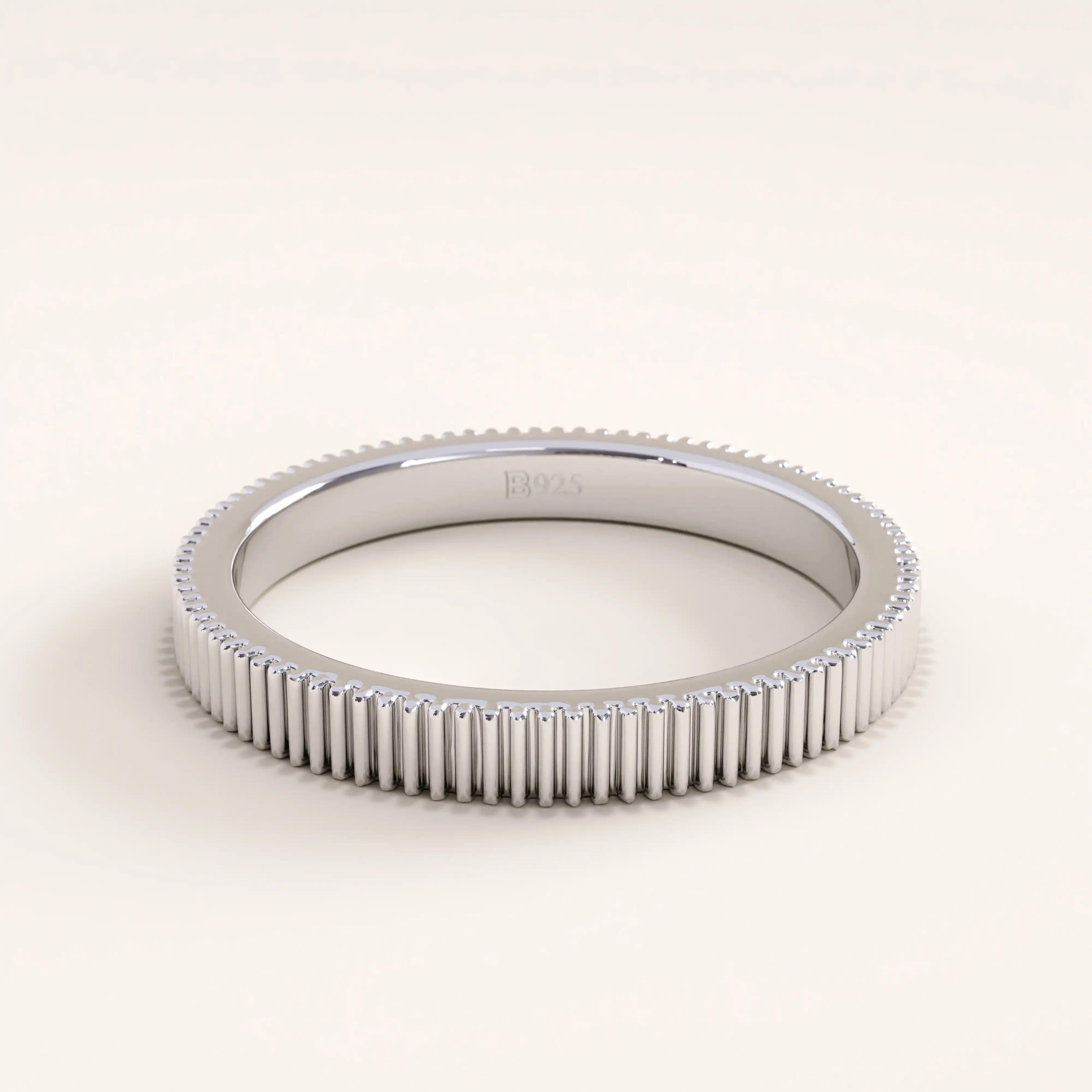 Silver vermeil lined band ring with a detailed ridged texture and sleek polished finish, perfect for a contemporary unisex jewelry style.
