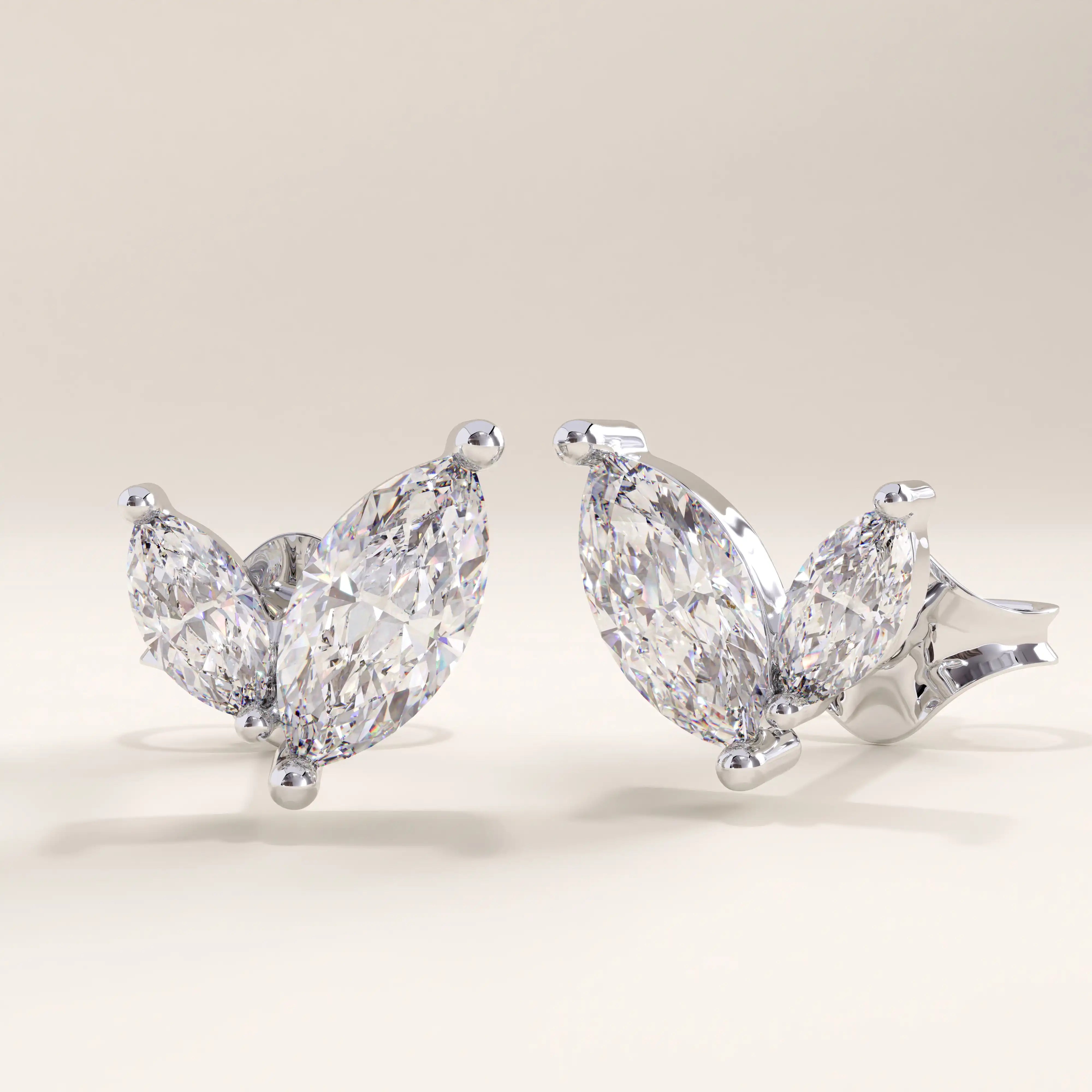 Silver vermeil marquise leaf earrings crafted with twin marquise-cut cubic zirconia stones in a delicate leaf-inspired setting, offering timeless sparkle and elegance.
