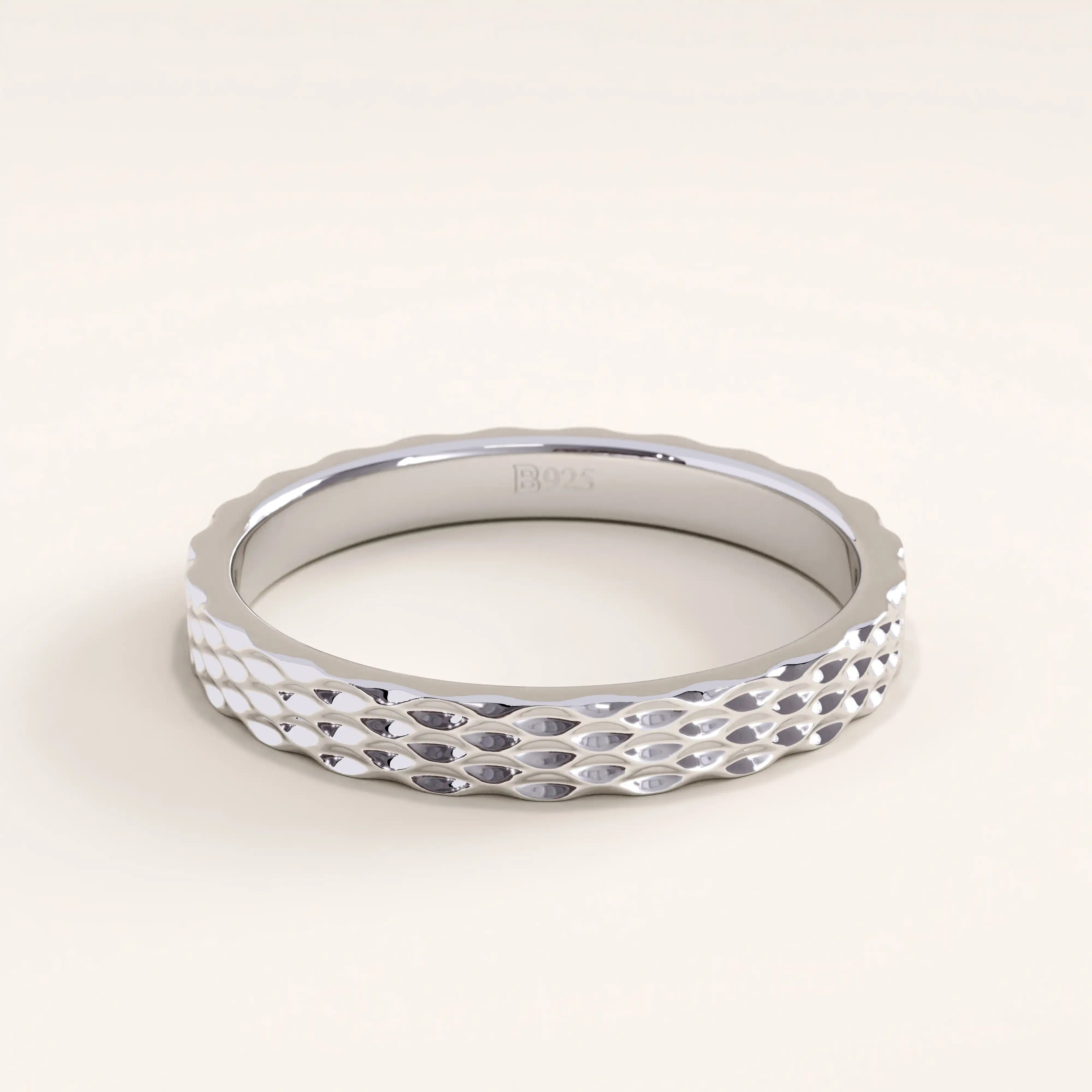 Silver vermeil patterned band ring with a subtle diamond-cut texture that adds depth and shine, perfect for everyday elegance.
