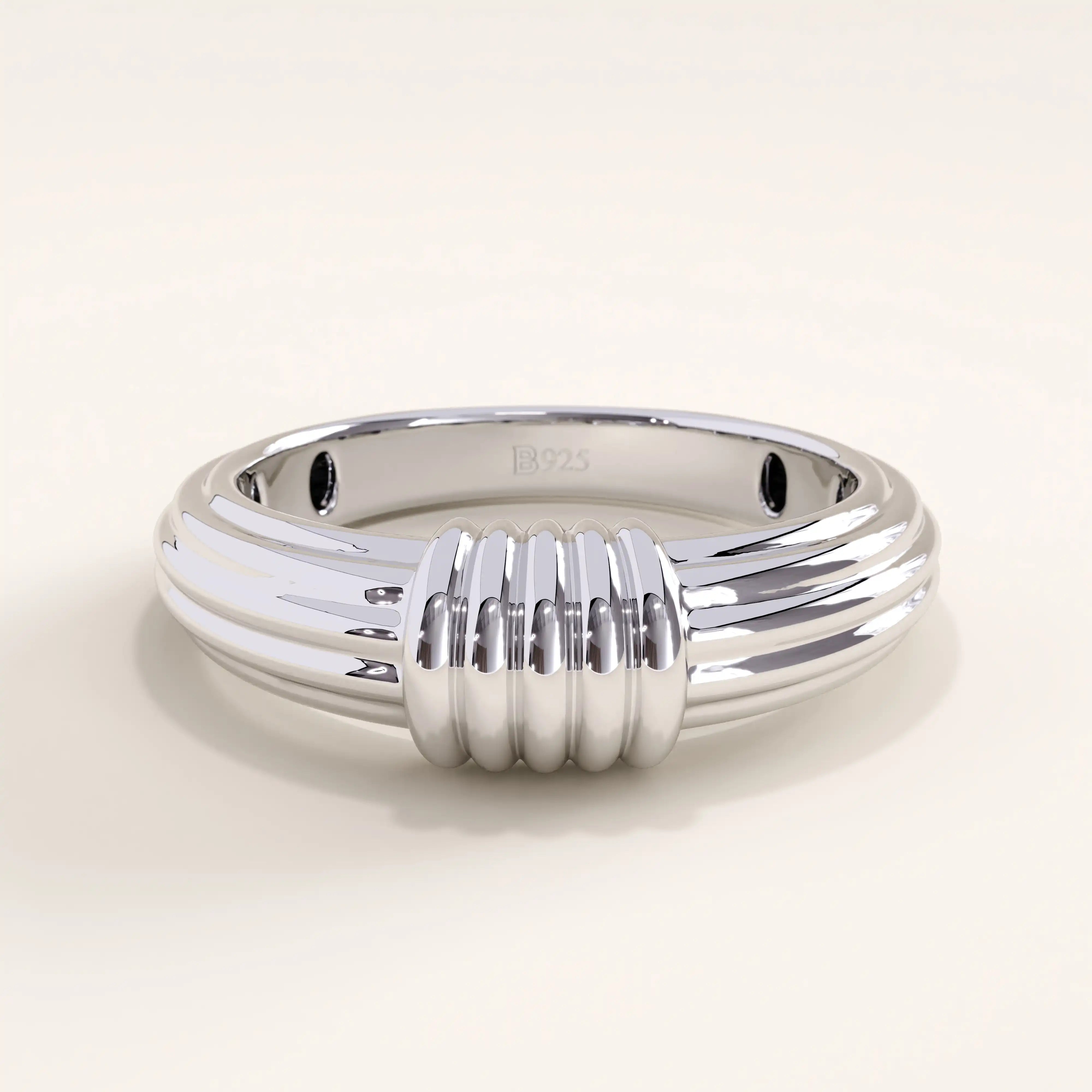 Silver vermeil ribbed dome ring with a sleek grooved band design, minimalist yet statement piece perfect for stacking or solo styling.
