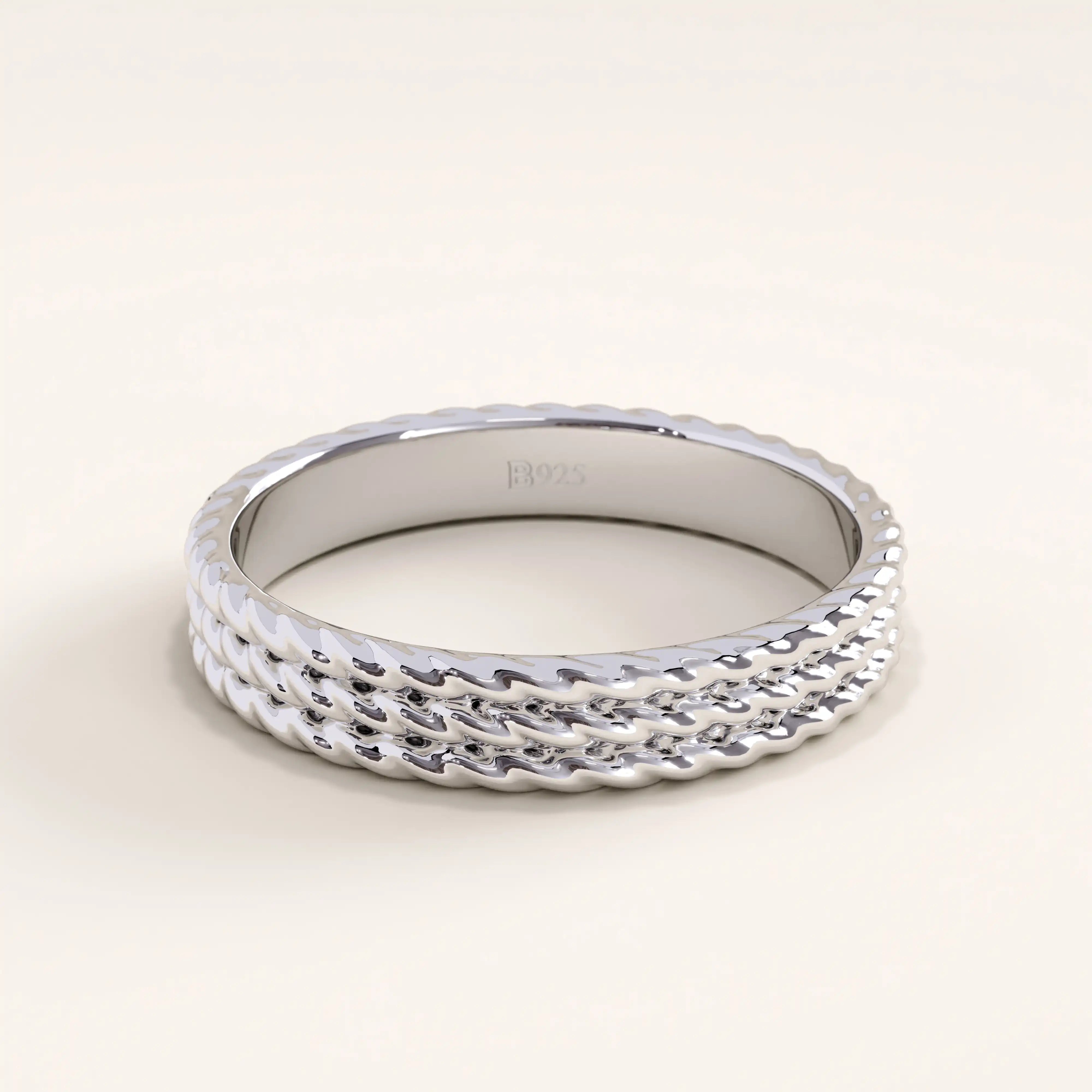 Silver vermeil rope band ring with a detailed triple-rope pattern and smooth shine, a versatile piece perfect for stacking or solo wear.
