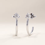 Silver vermeil solo hoop earrings designed with a polished curved band and a single cubic zirconia stone at the center, combining minimalist style with elegant shine.
