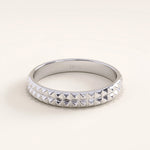 Silver vermeil square band ring with pyramid-like detailing and reflective surface, offering a bold yet refined everyday accessory.
