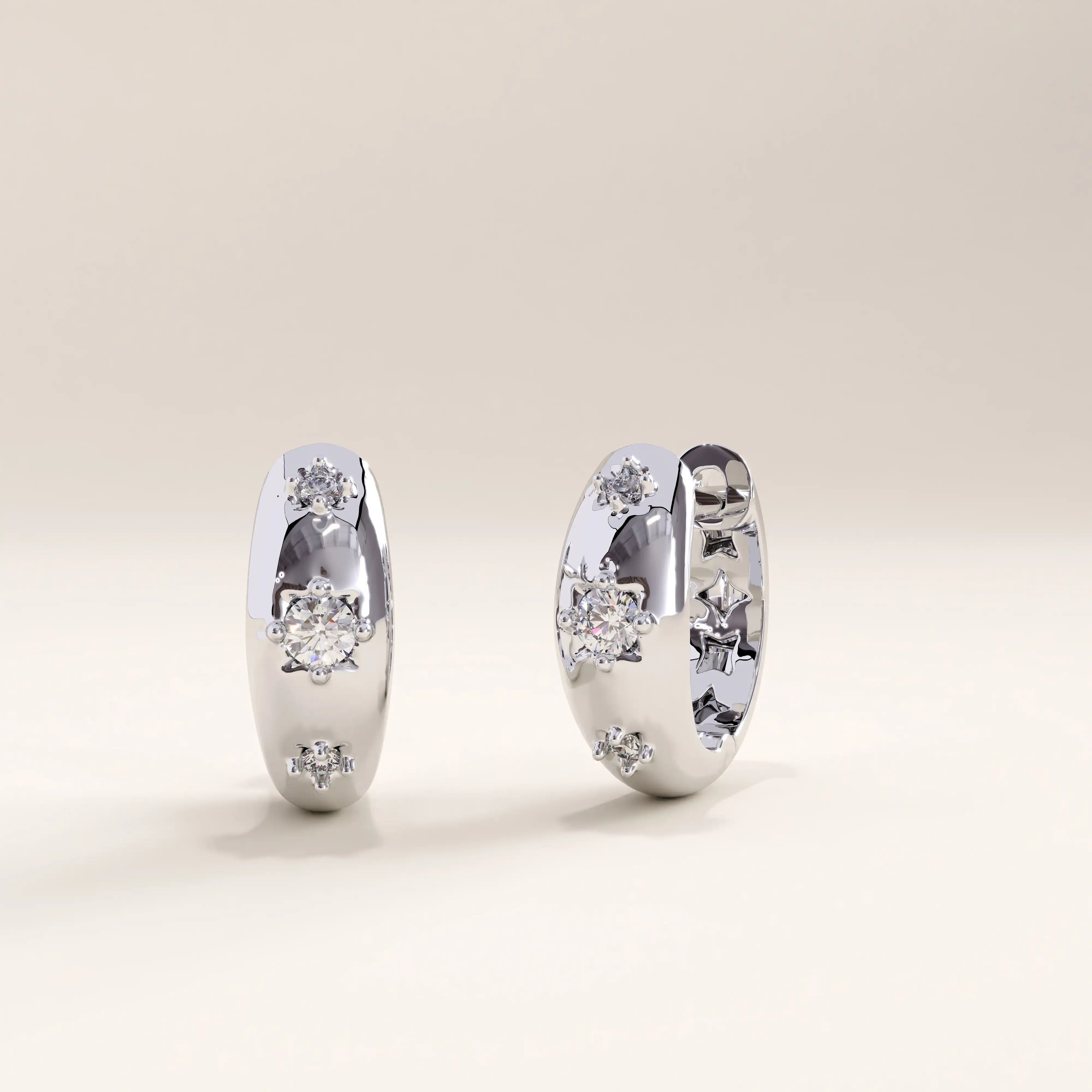 Silver vermeil star hoop earrings with sparkling cubic zirconia accents and star motifs, blending celestial charm with a sleek, refined silhouette.
