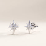 Silver vermeil star stud earrings with an intricate starburst motif and a central cubic zirconia stone for a touch of cosmic sparkle and elegance.
