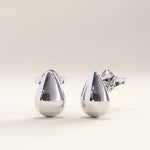Silver vermeil teardrop stud earrings with a sleek, sculptural silhouette and mirror-like shine, offering refined simplicity and everyday elegance.
