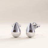 Silver vermeil teardrop stud earrings with a sleek, sculptural silhouette and mirror-like shine, offering refined simplicity and everyday elegance.
