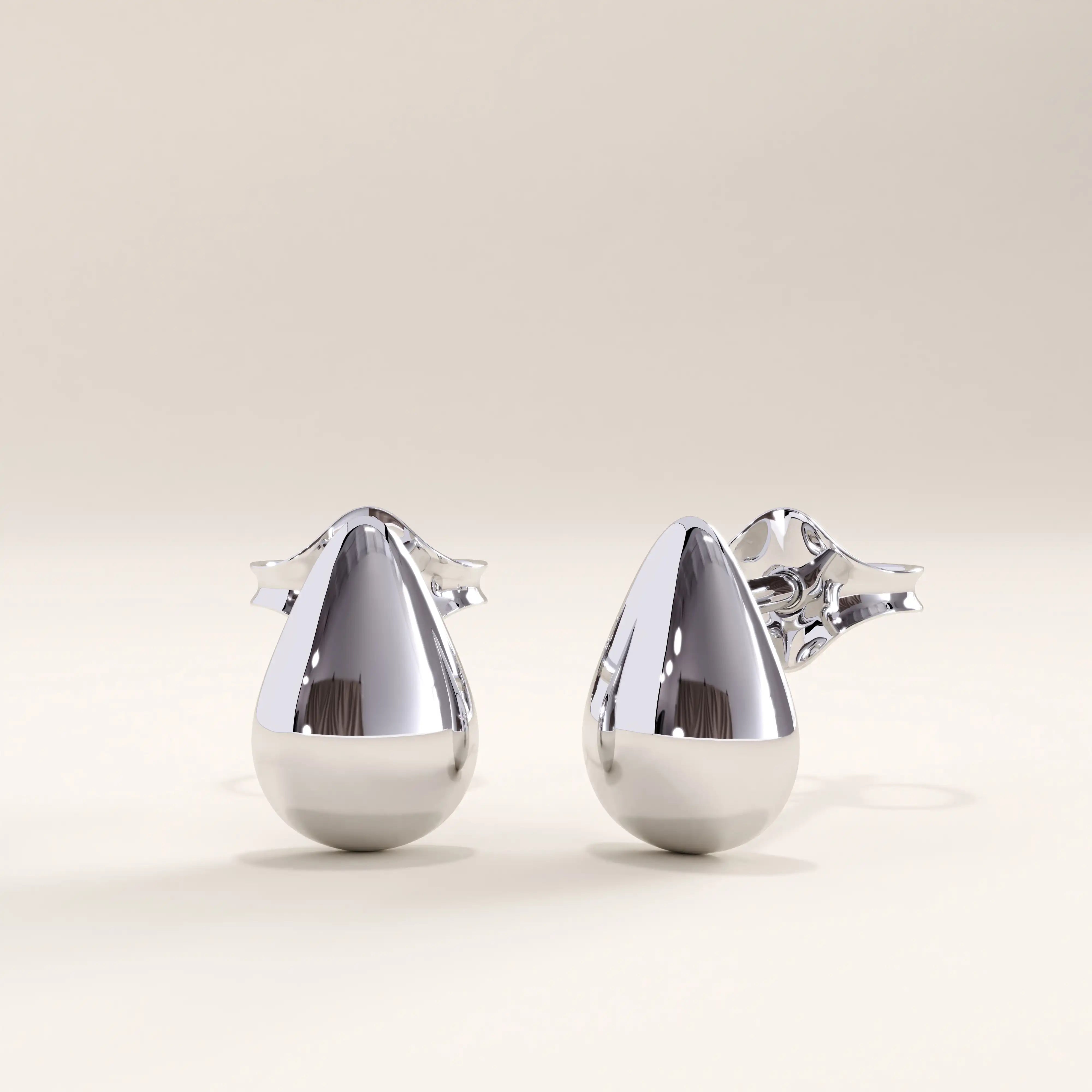 Silver vermeil teardrop stud earrings with a sleek, sculptural silhouette and mirror-like shine, offering refined simplicity and everyday elegance.
