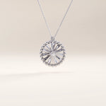 Silver vermeil textured coin necklace showcasing a circular pendant with a sculpted sunburst design and beaded edge, centered with a sparkling cubic zirconia for timeless shine.
