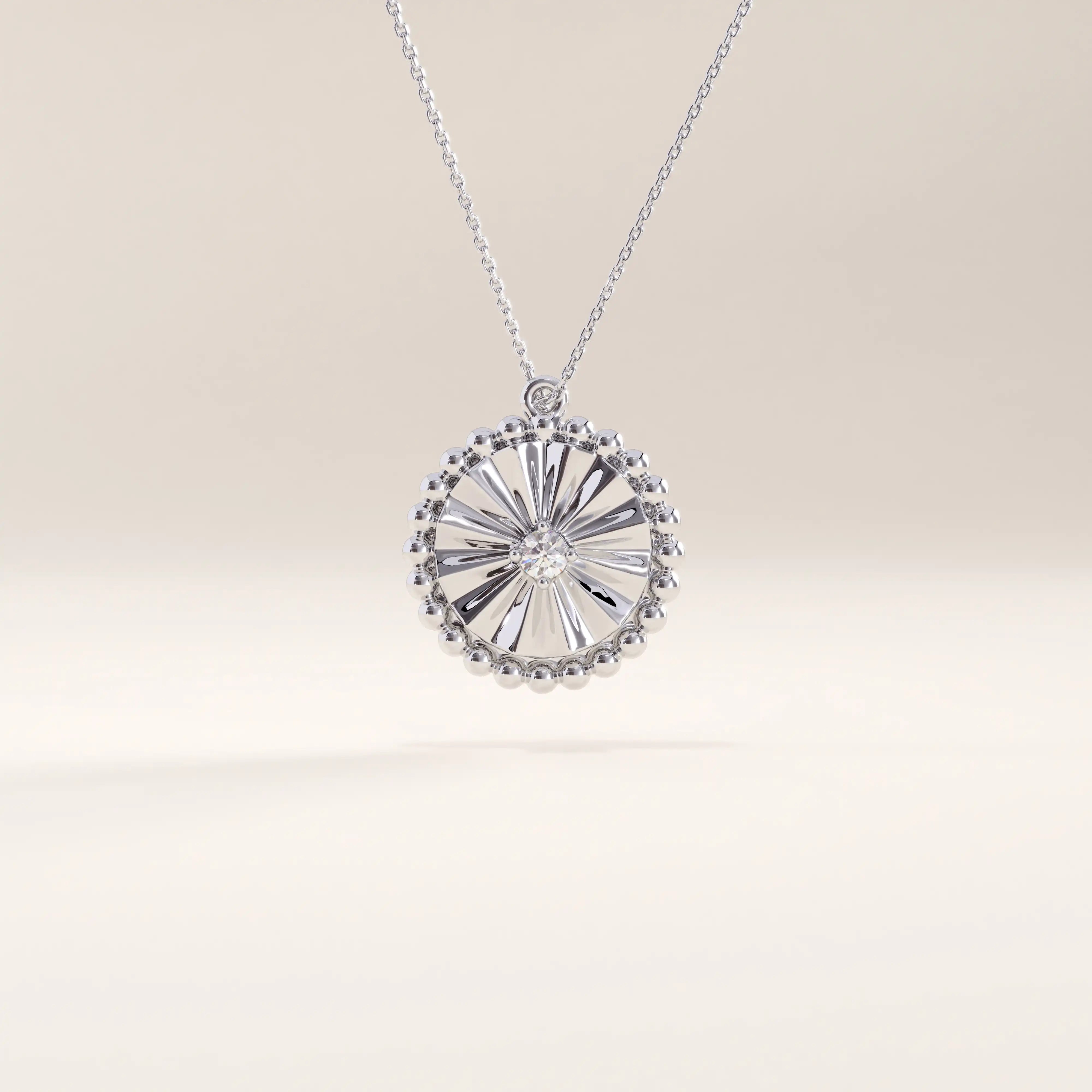Silver vermeil textured coin necklace showcasing a circular pendant with a sculpted sunburst design and beaded edge, centered with a sparkling cubic zirconia for timeless shine.
