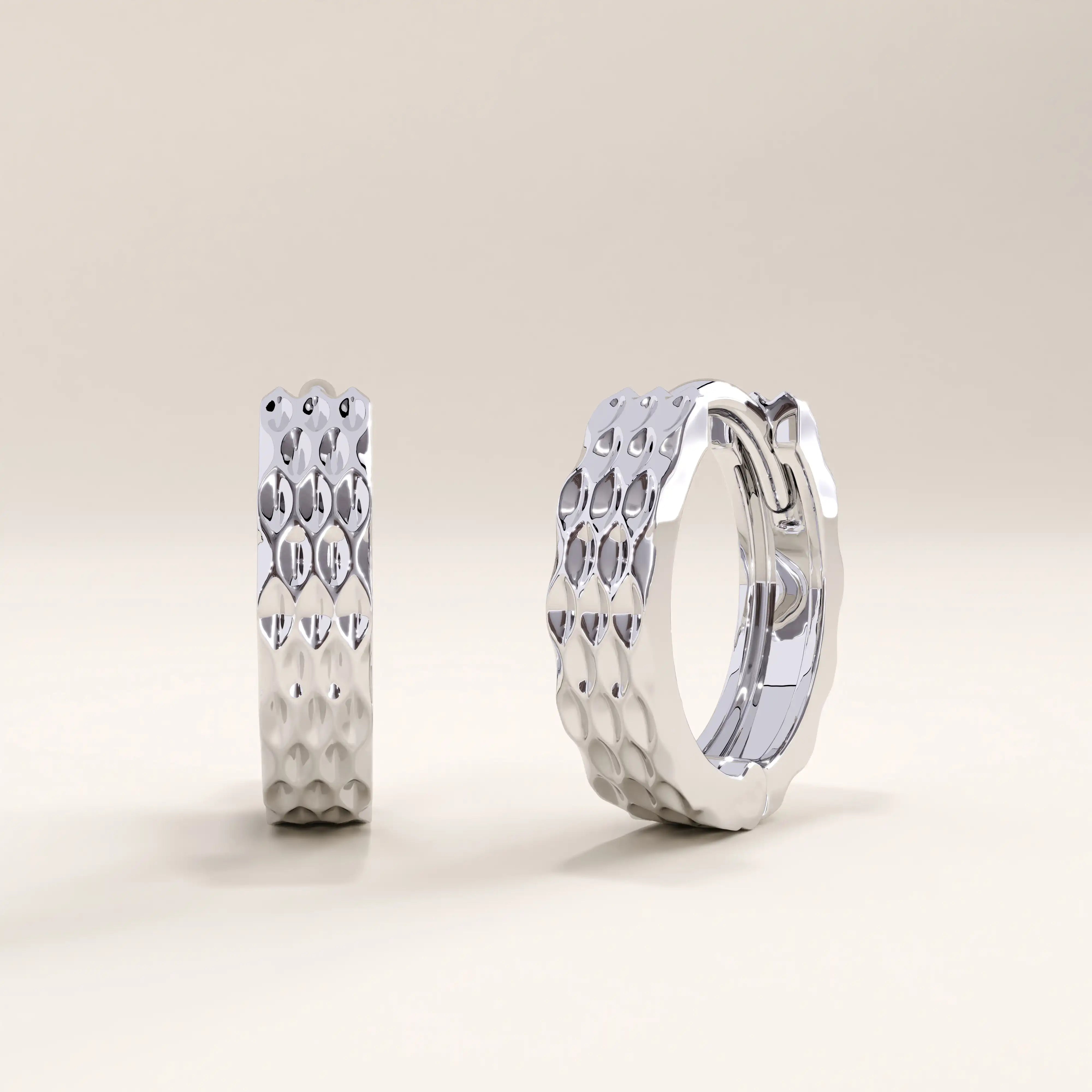 Silver vermeil textured hoop earrings with a shimmering faceted design for a modern, handcrafted look that enhances any style with understated elegance.
