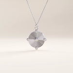 Silver vermeil unique round necklace showcasing a modern concentric ring pendant accented with five cubic zirconia stones, blending sleek geometry with elegant sparkle.
