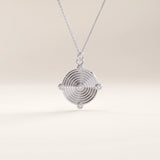 Silver vermeil unique round necklace showcasing a modern concentric ring pendant accented with five cubic zirconia stones, blending sleek geometry with elegant sparkle.
