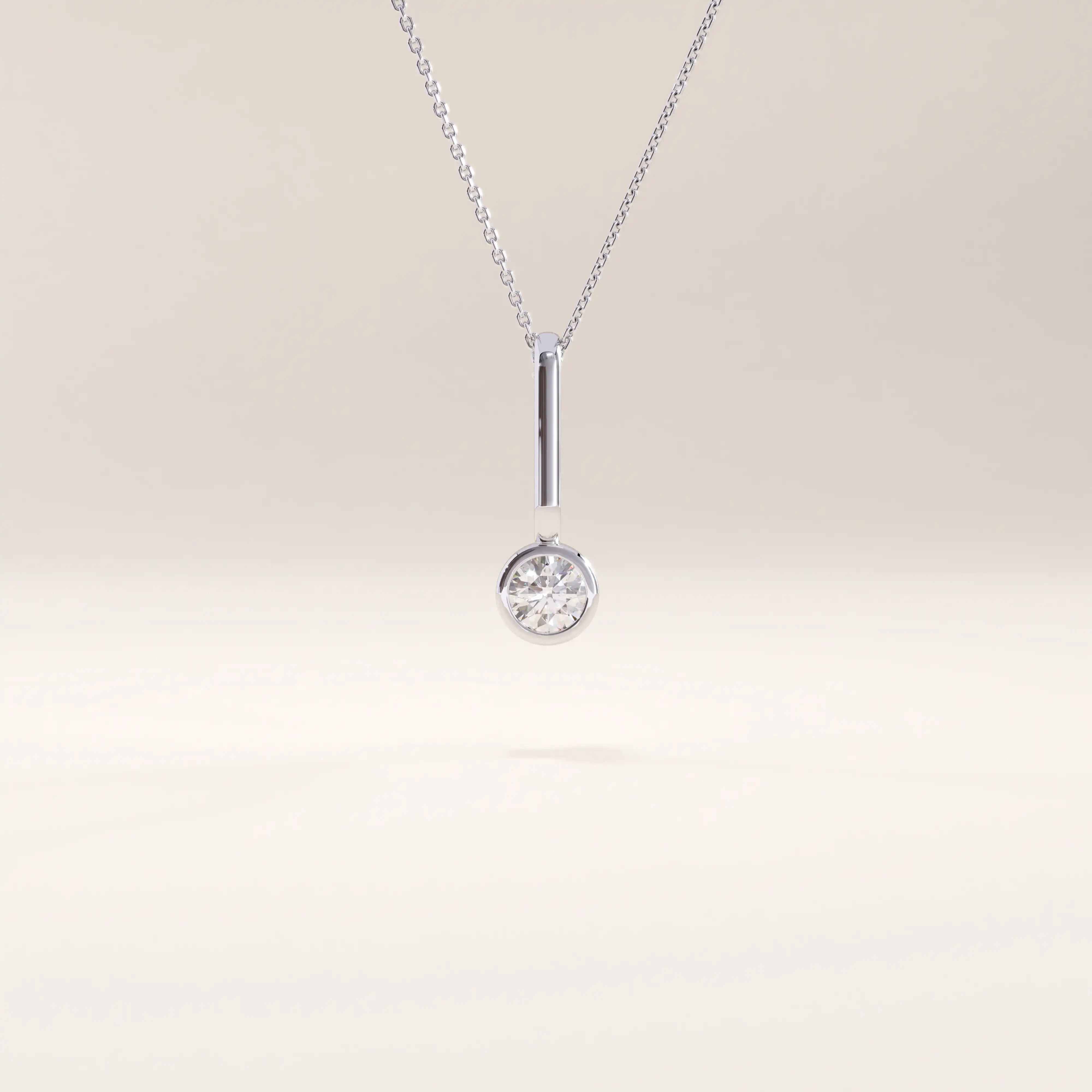 Silver vermeil unique solo necklace showcasing a contemporary pendant with a single cubic zirconia in a polished bezel setting for understated sophistication.
