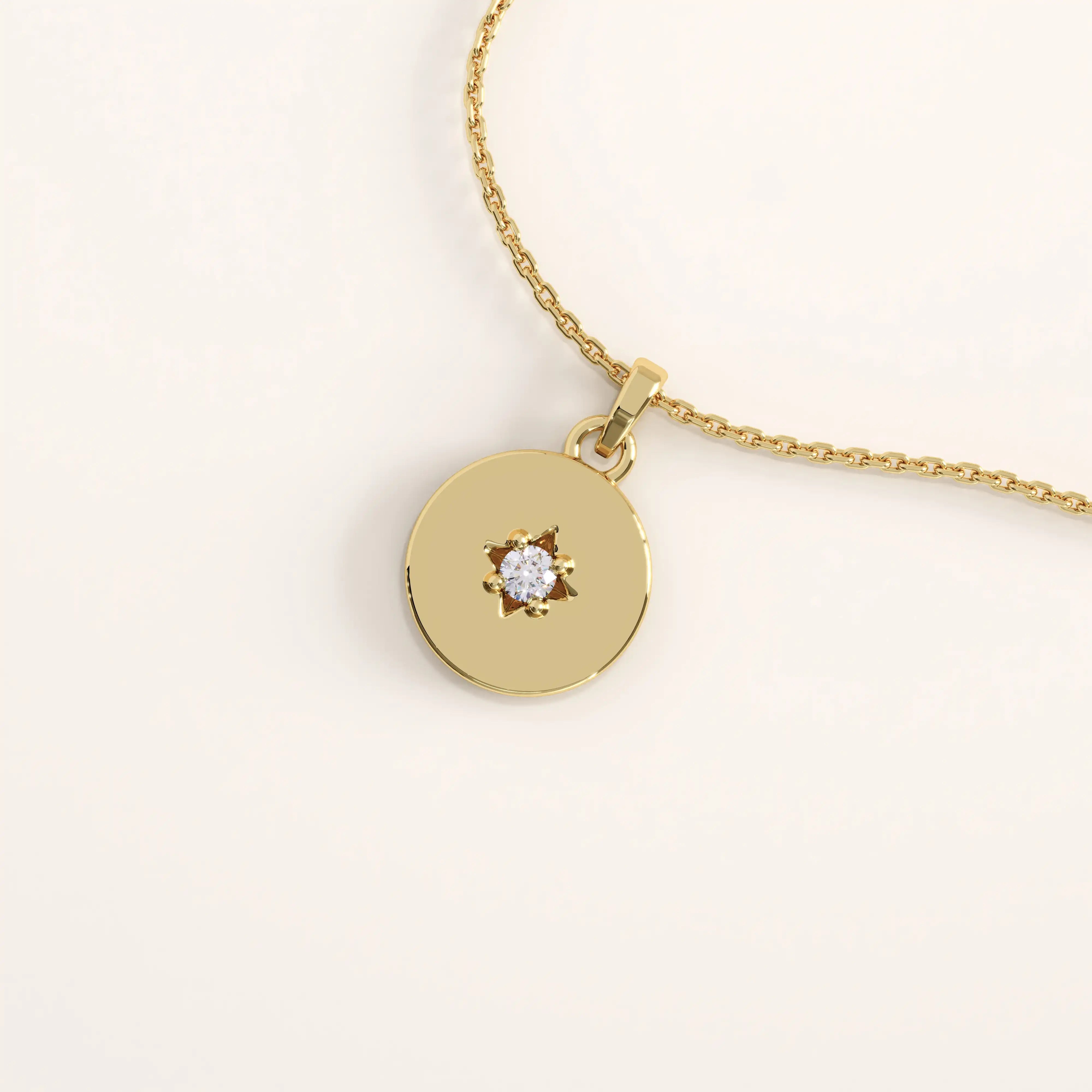 14k gold vermeil starburst coin necklace featuring a polished round pendant adorned with a radiant star engraving and a sparkling cubic zirconia at the center.
