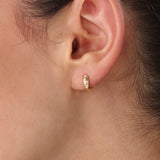 Model wearing 14k gold vermeil star hoop earrings showcasing a luminous gold finish and twinkling stone details, perfect for adding celestial elegance to any outfit.
